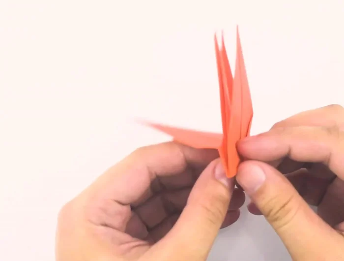 Fold wings down, then fold the tip of the head down and gently pull out the wings.