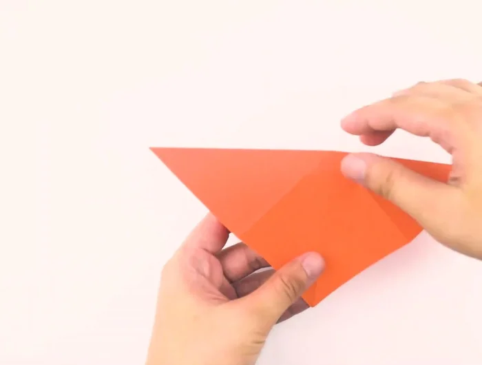 Fold the top corners to the bottom, pressing the sides in to form a small diamond.