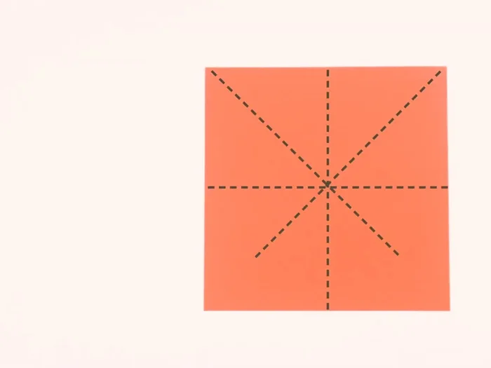 Fold the square paper in half vertically, then horizontally, and diagonally. Unfold after each fold.