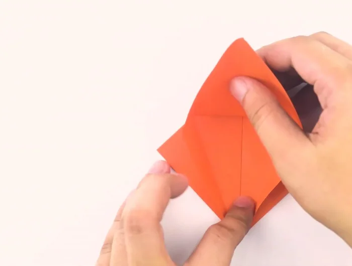 Flip the paper over and repeat the process to create another long skinny diamond.