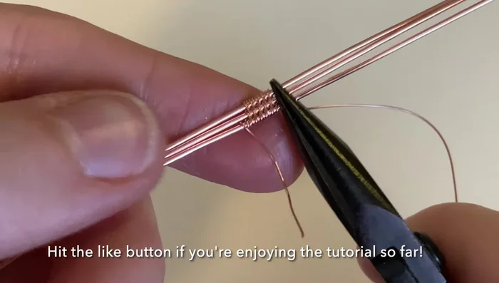 Compress the weave and wrap the weaving wire around the bottom base wire three more times to secure it. Trim excess wire.