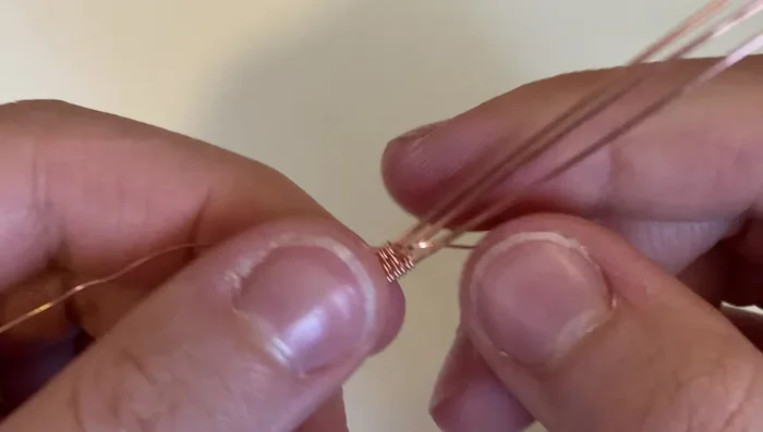 Bend the wires straight up and parallel to each other at the point where the coil ends.