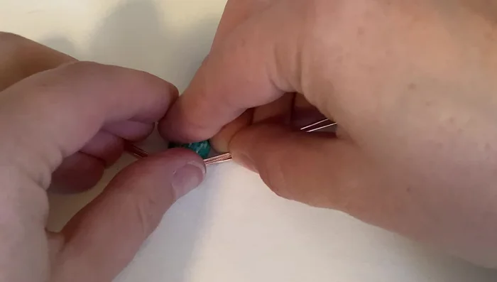 Bend the wires straight up and parallel to each other at the point where the coil ends.