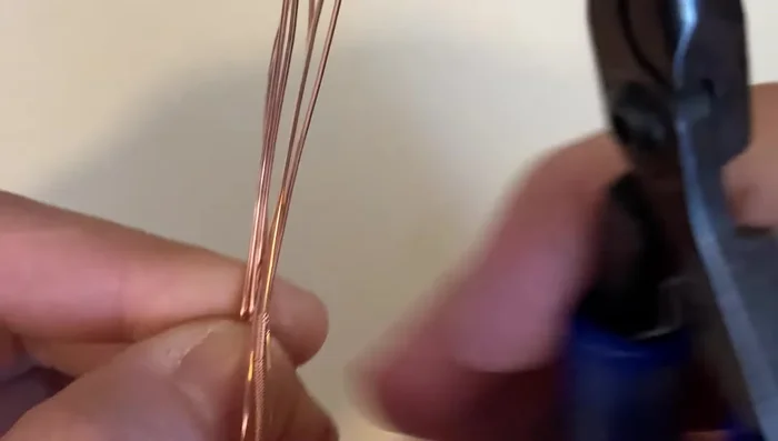 Bend the wires straight up and parallel to each other at the point where the coil ends.