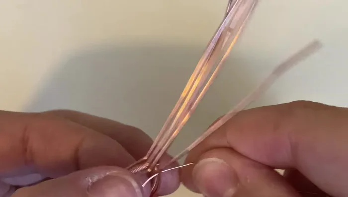 Wrap the weaving wire around all wires three times to bind them together.