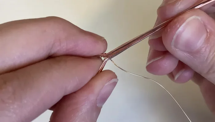 Wrap the weaving wire around all wires three times to bind them together.