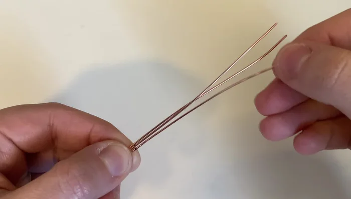 Arrange three 20-gauge wires parallel to each other.