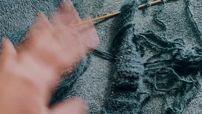 Continue knitting in stockinette stitch (knit one row, purl one row, repeat) until the hood is wide enough to fit around your head.