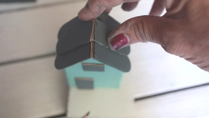 Glue the house to the base: Apply wood glue to the bottom base and secure the house.