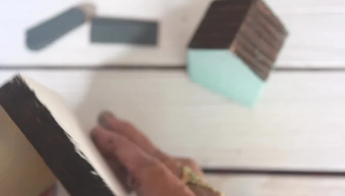 Sand the base: Once the paint is dry, sand the edges of the base and house.