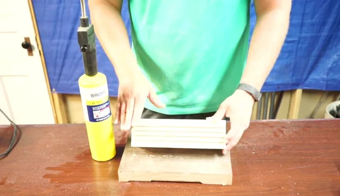 Use a torch to burn the wood, creating a charred finish. Adjust the burning intensity to your liking.