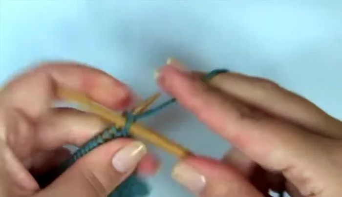 Shape the thumb: Knit 13 stitches, increase (right-leaning increase), knit following stitch, increase (left-leaning increase), knit to end of row. Repeat increases every other row.