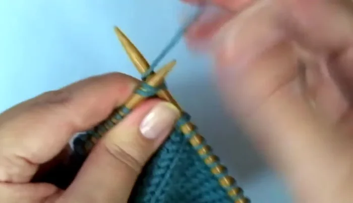 Attach yarn at the base of the thumb; pick up and knit one stitch on each side of the base of the thumb. 