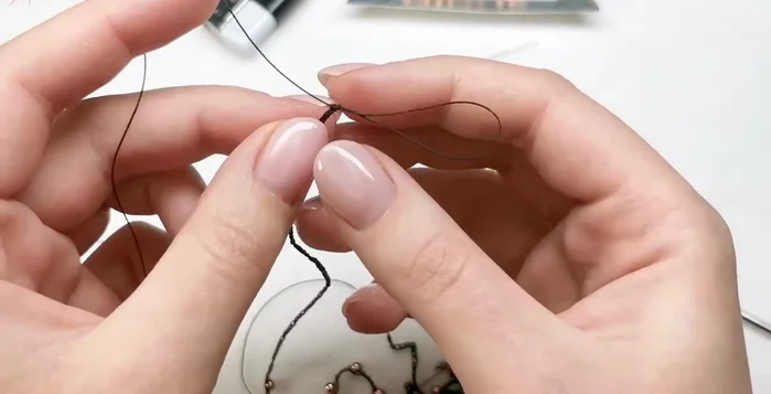 Finish chain: Secure the chain by threading the end through the last loop and cutting off excess cord.