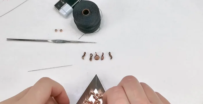 Prepare your beads: Separate beads for the ends and four beads to space out the charms.