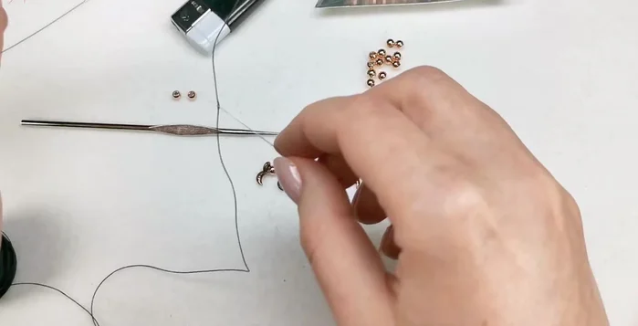 String beads onto cord: Thread the cord through a big eye needle and string on the prepared beads.