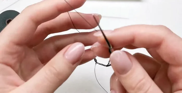 Add beads: Add one bead at a time, creating three chain stitches between each bead. Make larger loops to accommodate the charms.