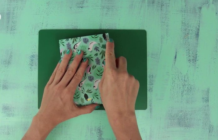 Glue balsa wood sheets together to form a pouch.