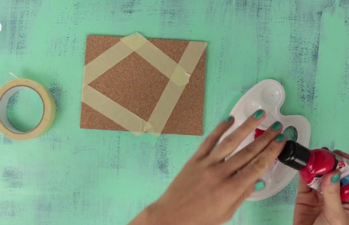 Paint triangles on cork using masking tape as a stencil.