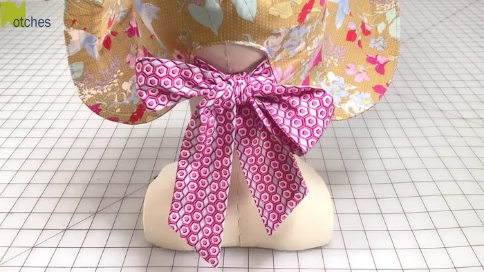 Prepare the fabric: Cut out all the pattern pieces, including the crown, brim, and straps, following the grain lines. Cut notches at specific points for easy identification and assembly.