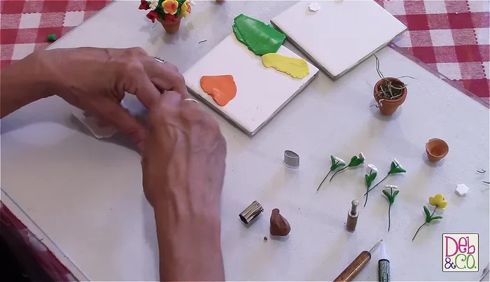 Create tulip flowers: Use three leaf-shaped cutters (red clay) and join them together in the center to form a tulip shape.