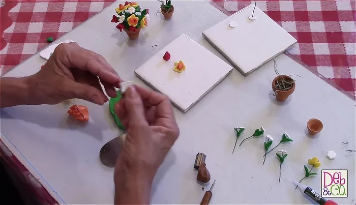 Attach leaves to stems: Wrap the leaves around the wire stems, securing them with a small amount of glue if necessary.