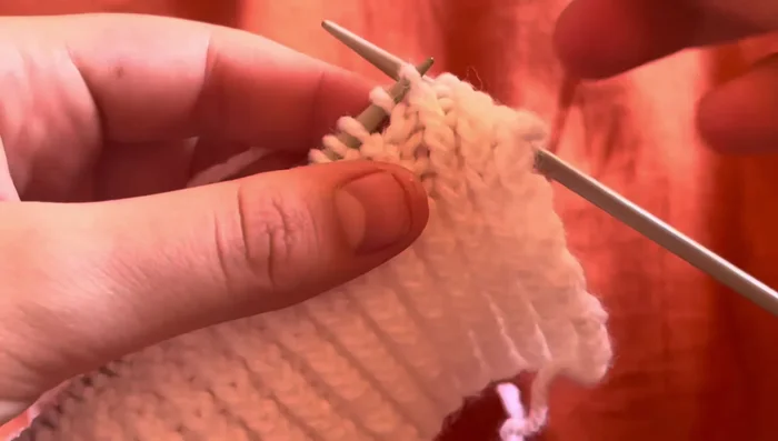 Panel B: Purl three stitches, slip one stitch to the back of the work, knit two, slip stitch back, purl, knit one, slip two stitches to the front of the work, purl next stitch, place two stitches back on the needle, knit, then purl three stitches again.