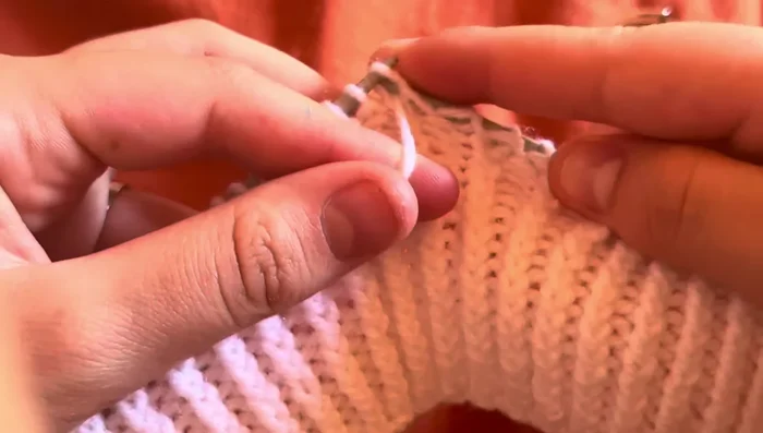 Panel B: Purl three stitches, slip one stitch to the back of the work, knit two, slip stitch back, purl, knit one, slip two stitches to the front of the work, purl next stitch, place two stitches back on the needle, knit, then purl three stitches again.