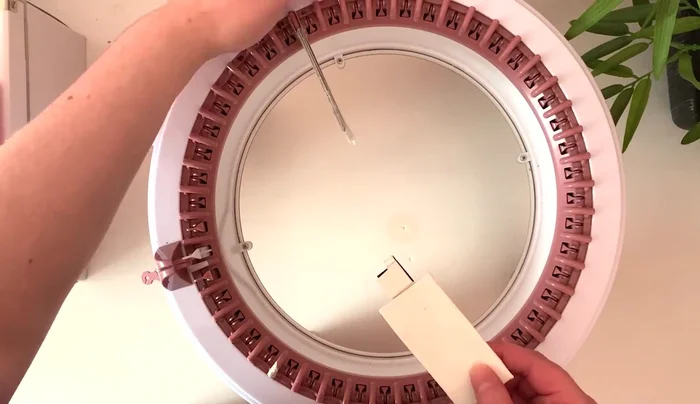 Prepare the knitting machine by adding extenders.