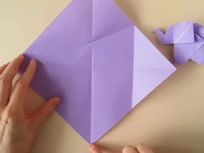 Open the flap, bring the lower corner to the pinch mark and crease.