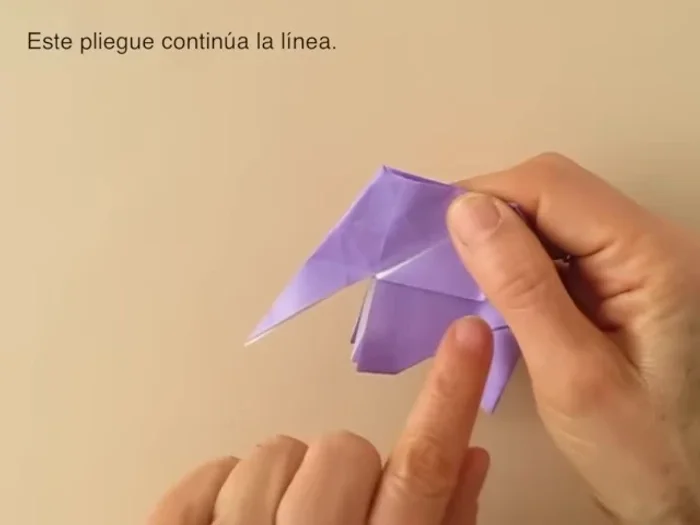 Blunt the corners. Fold the tail inside. Fold the ears outward.