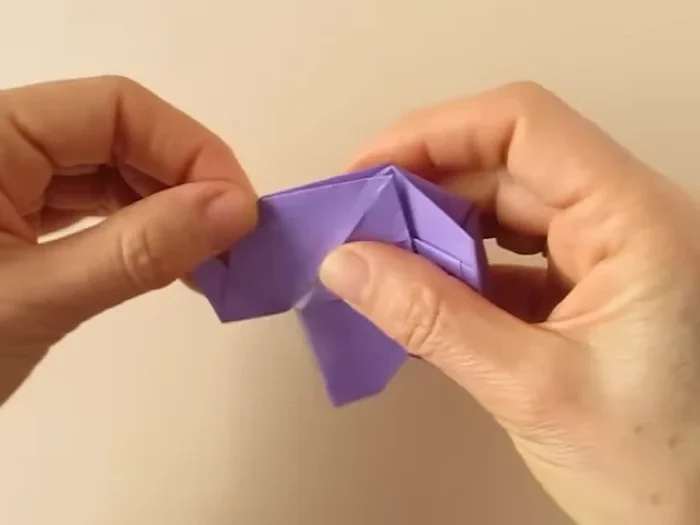 Blunt the corners. Fold the tail inside. Fold the ears outward.