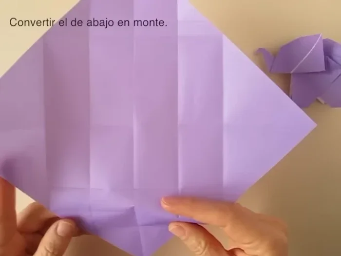 Fold along the center so that the central fold is a mountain fold. Rotate so that the point is up, fold and collapse.