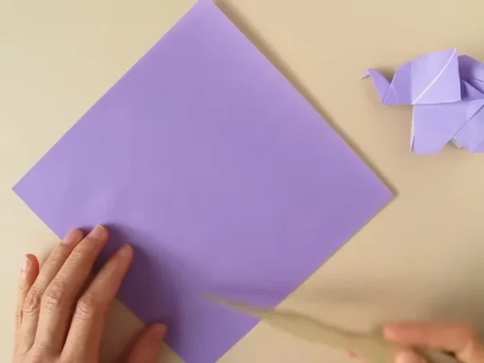 Open the flap, bring the lower corner to the pinch mark and crease.