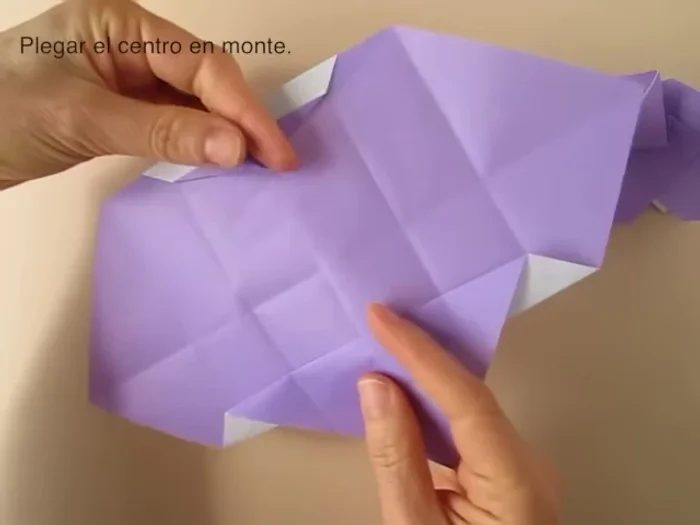 Fold along the center so that the central fold is a mountain fold. Rotate so that the point is up, fold and collapse.