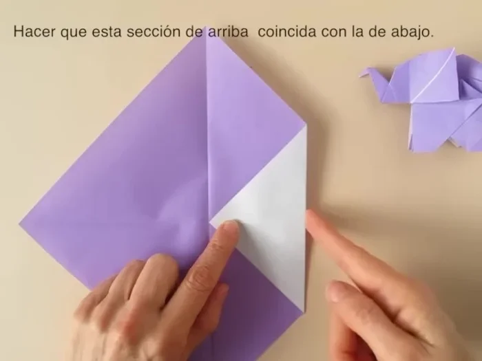 Open the flap, bring the lower corner to the pinch mark and crease.