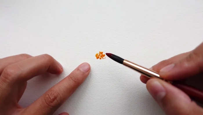 Gently tap in a vibrant pink color around the yellow center, leaving some white space.