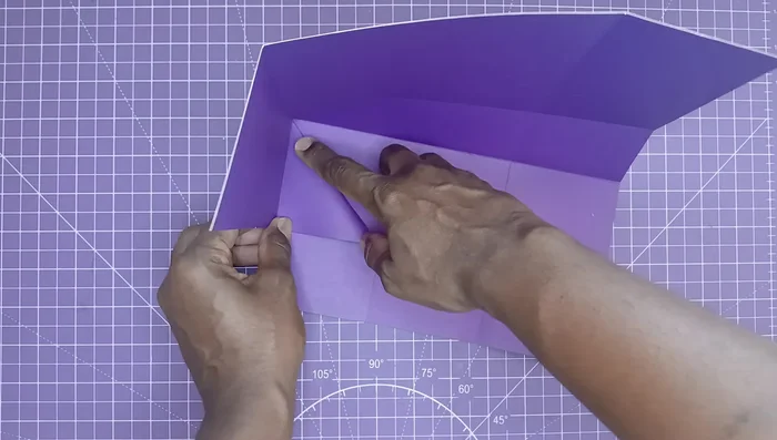 Fold all sides and flatten. Bring the top edges up and adhere them with glue and a bone folder.