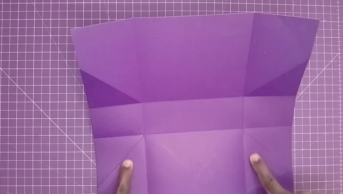 Fold all sides and flatten. Bring the top edges up and adhere them with glue and a bone folder.