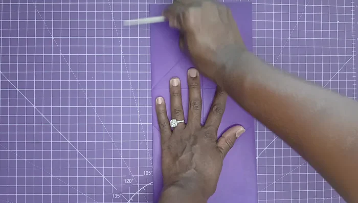 Fold all sides and flatten. Bring the top edges up and adhere them with glue and a bone folder.