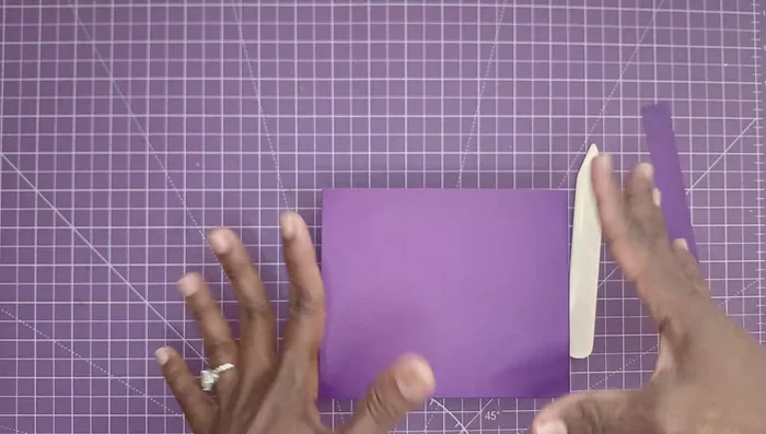 Add the straps by placing them between the layers of the bag and securing them with glue.