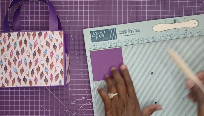 Create a gift card holder by scoring and folding a 3.25 x 3 inch piece of paper, then adding decorative layers inside.