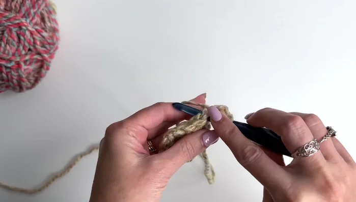 Repeat Row 2's treble cluster and chain two pattern for subsequent rows, adding an additional treble cluster between the beginning and corner stitches with each row. Continue until desired size (20 rows for a 62x27 shawl).