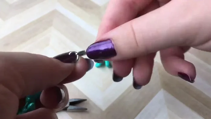 Close the jump ring securely with pliers. Ensure the ring is closed tightly to prevent the charm from detaching.