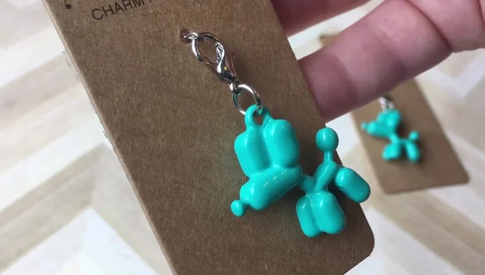 Remove the lobster clasp (if present) from your charm using pliers.