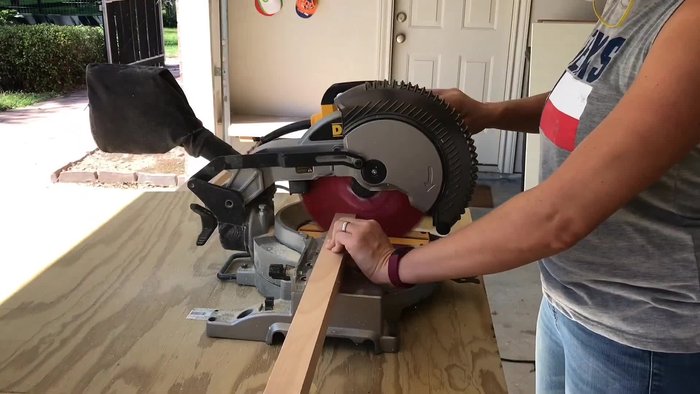 Drill three-quarter inch deep holes in the pine blocks. Use painter's tape to measure the depth of the hole to ensure consistency.