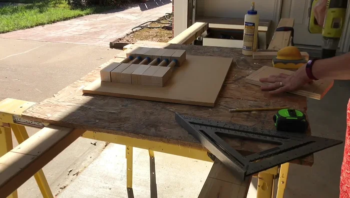 Create a jig using an 11-inch wide board, marking and drilling holes for screw placement to match the drawer.