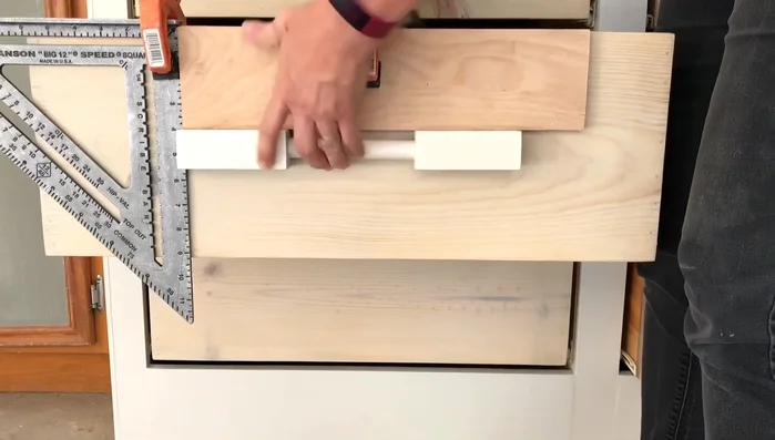 Install the drawer pulls using self-tapping screws to avoid splitting the wood.