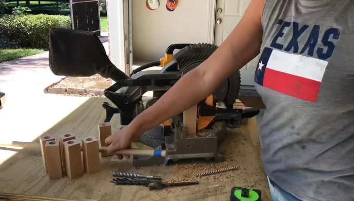 Drill three-quarter inch deep holes in the pine blocks. Use painter's tape to measure the depth of the hole to ensure consistency.