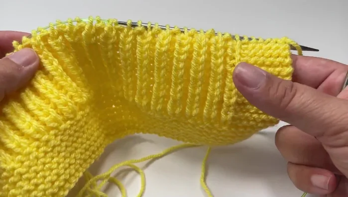 Begin the top edging with the wrong side facing you. Knit 11 rows of garter stitch (knit every stitch).